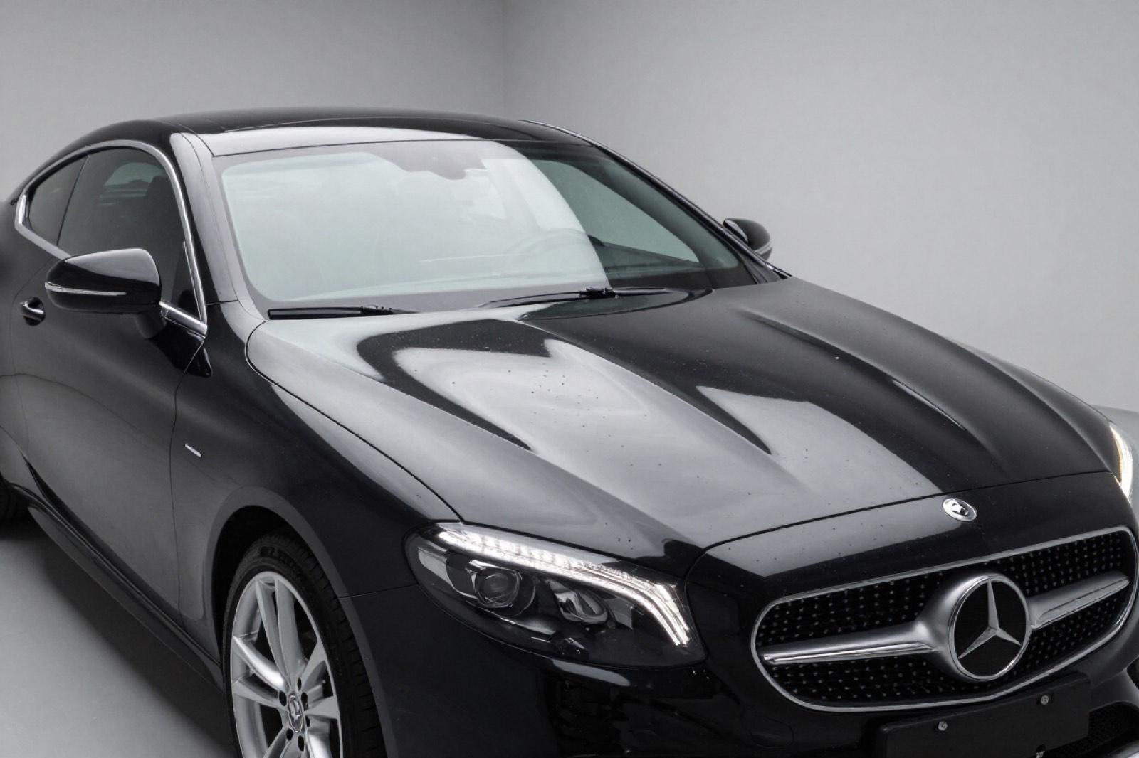 A gloss black Mercedes coupe with a mirror finish